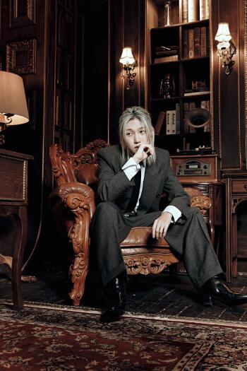 P1Harmony man in a suit poses in a lavish study for a Secret Society Scenes iPhone wallpaper.