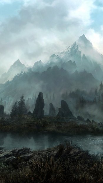 Vertical phone wallpaper (iPhone/Android) from The Elder Scrolls V: Skyrim: mist-shrouded peaks rise above dark pine forest, their silhouettes reflected in a glassy lake.