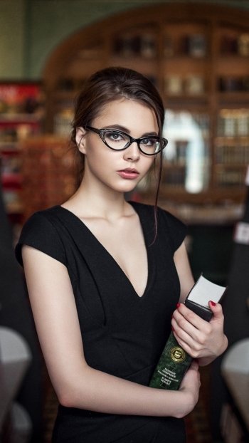 model glasses brunette brown eyes bokeh library woman Oktyabrina Maximova Phone Wallpaper