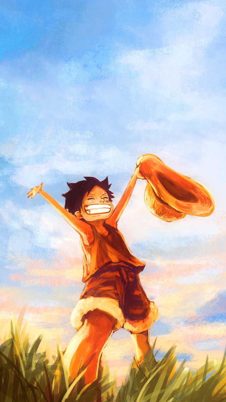 Phone wallpaper of Monkey D. Luffy (One Piece): young Luffy grinning, holding his straw hat aloft in a sunlit grassy field under a wide blue sky.