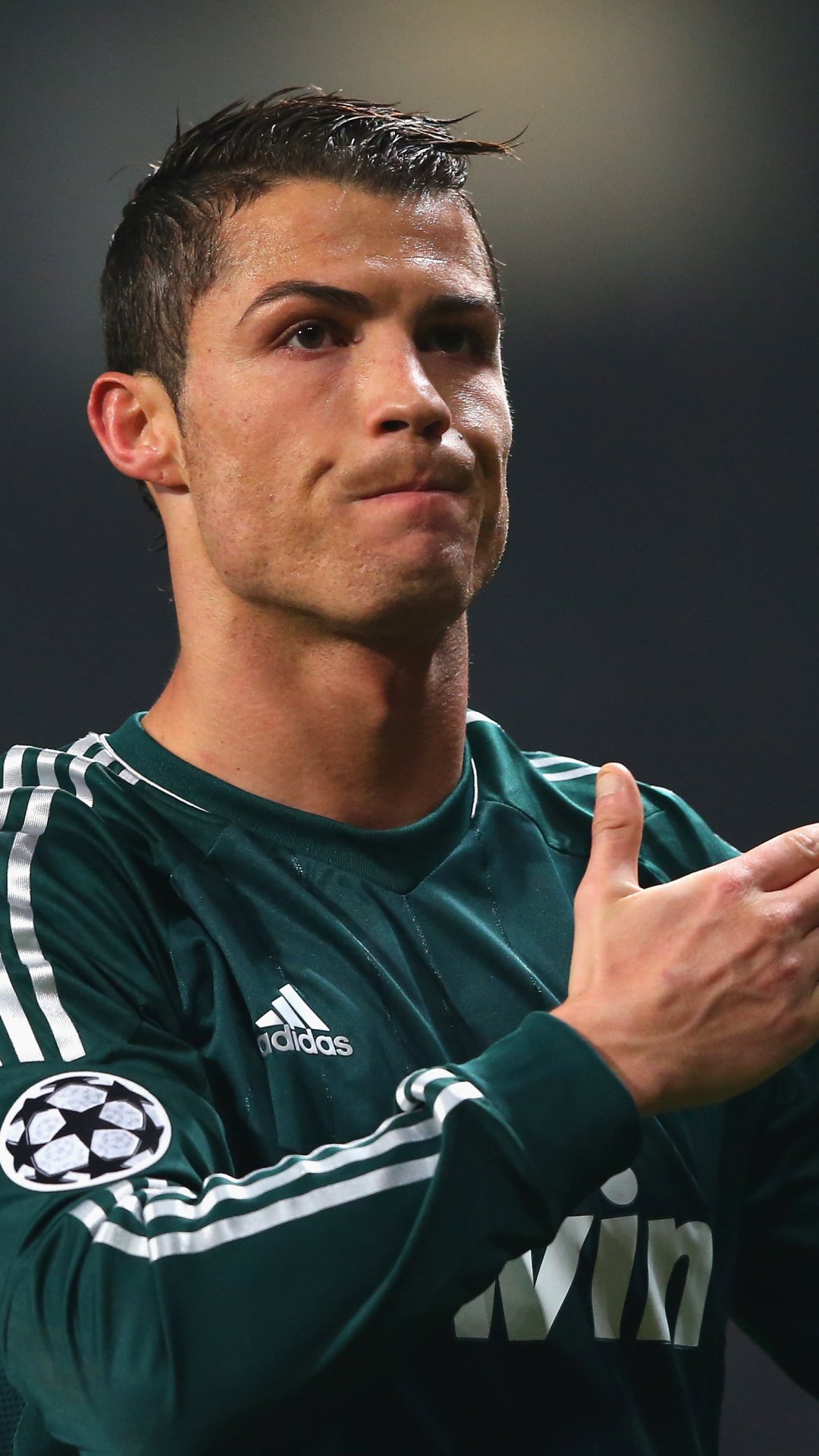 Portrait of Cristiano Ronaldo in a Real Madrid C.F. jersey, captured during a moment in a football match, designed as a phone wallpaper for iPhones and Android devices.