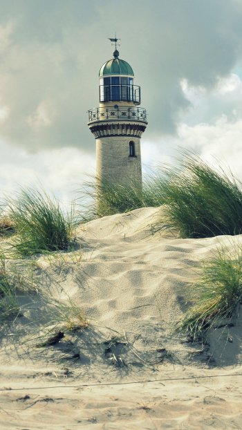 grass sand beach man made lighthouse Phone Wallpaper