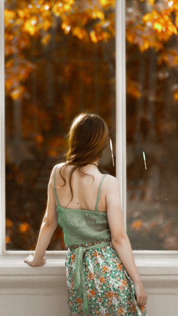 window redhead woman rear Phone Wallpaper