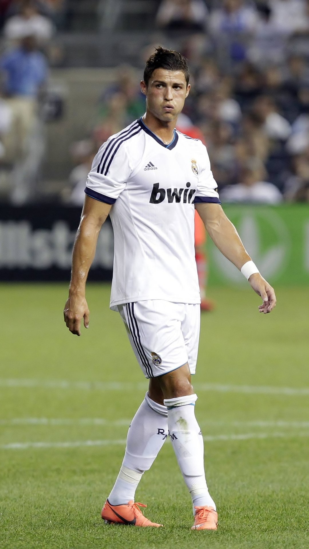 Phone wallpaper featuring Cristiano Ronaldo in Real Madrid C.F. kit during a match, highlighting the sportsmanship and iconic football moment for iPhone and Android displays.
