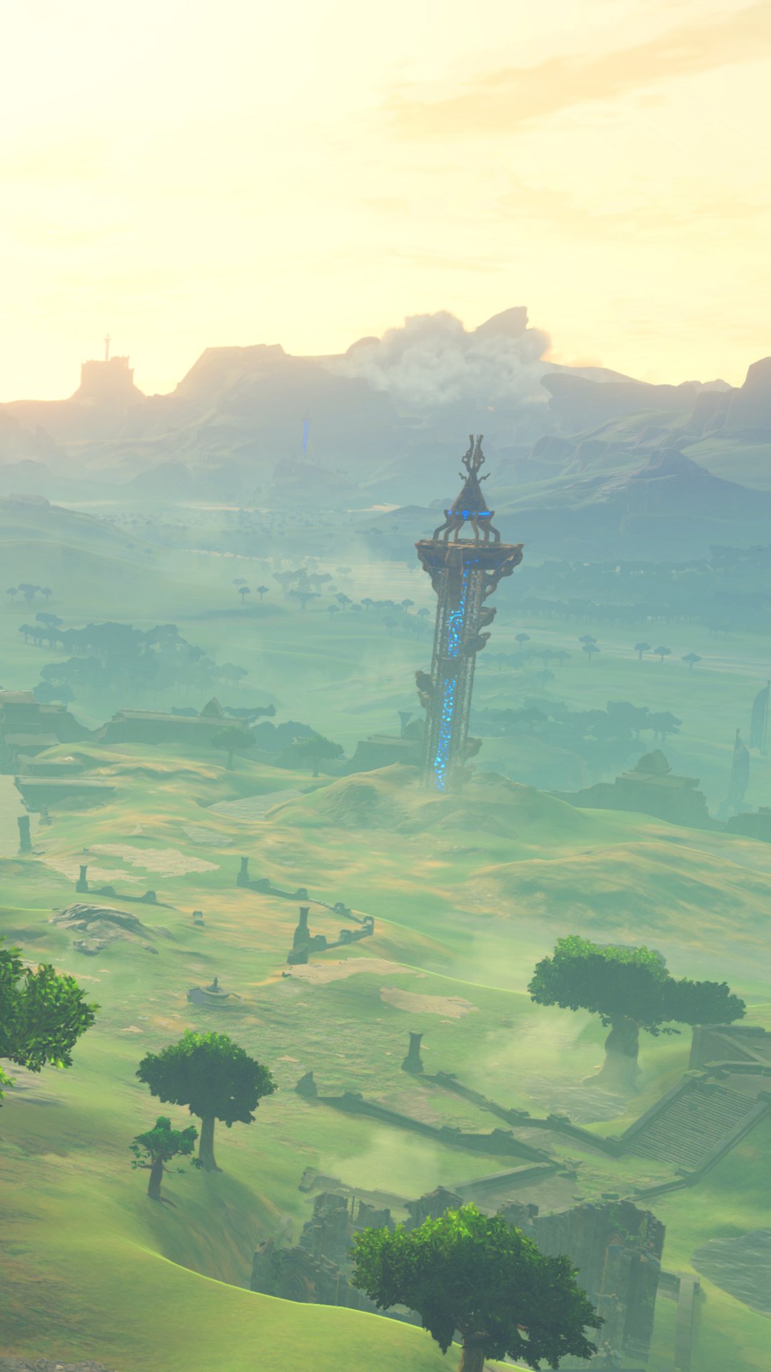 Phone wallpaper from the video game The Legend of Zelda: Breath of the Wild: misty sunrise over rolling green plains with a solitary Sheikah tower rising toward distant mountains.