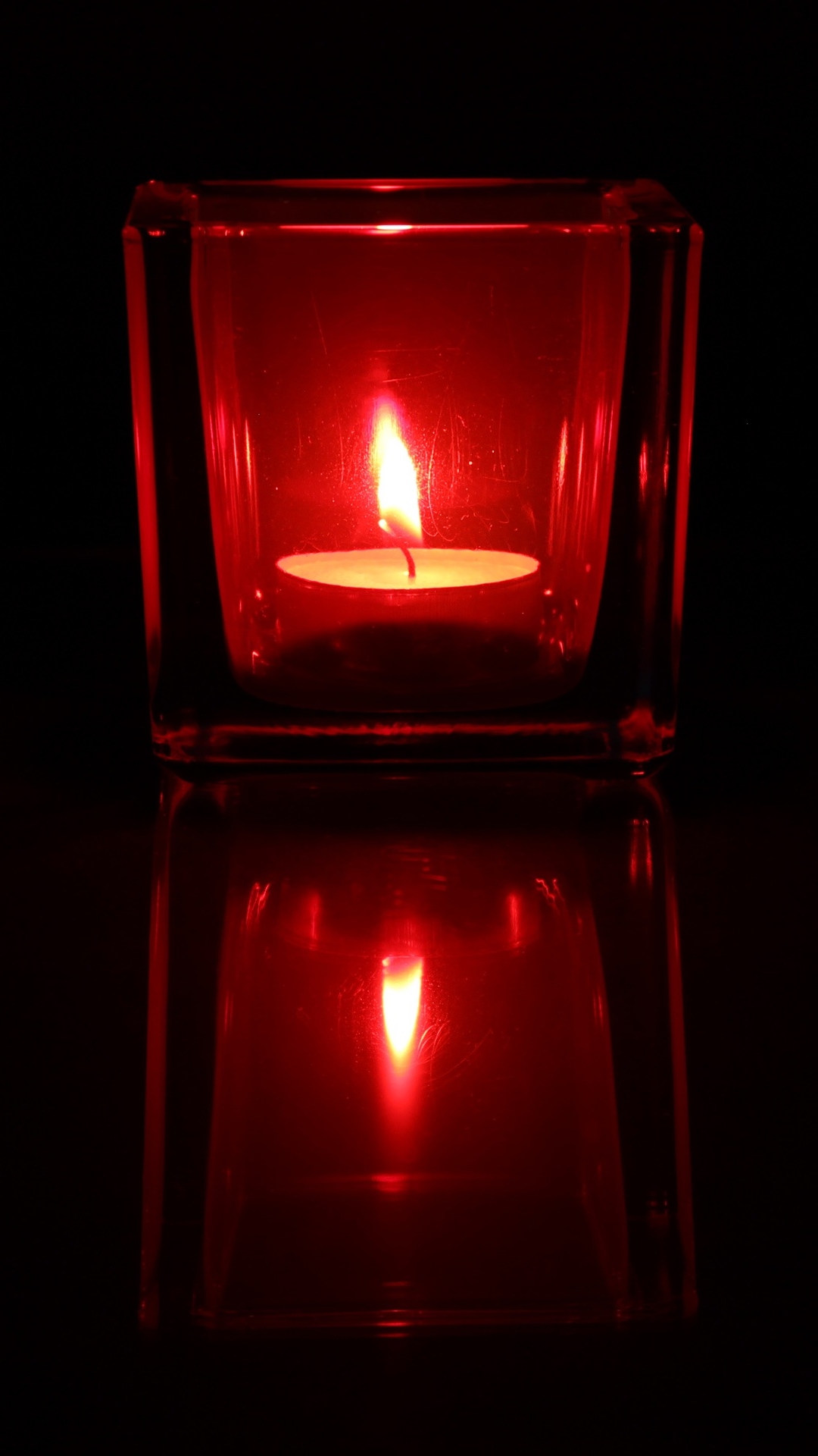 A tealight candle in a red glass