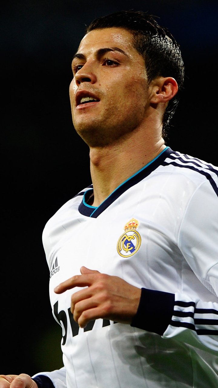Phone wallpaper featuring Cristiano Ronaldo in Real Madrid C.F. kit, capturing a focused moment in sports action, compatible with both iPhones and Android phones.