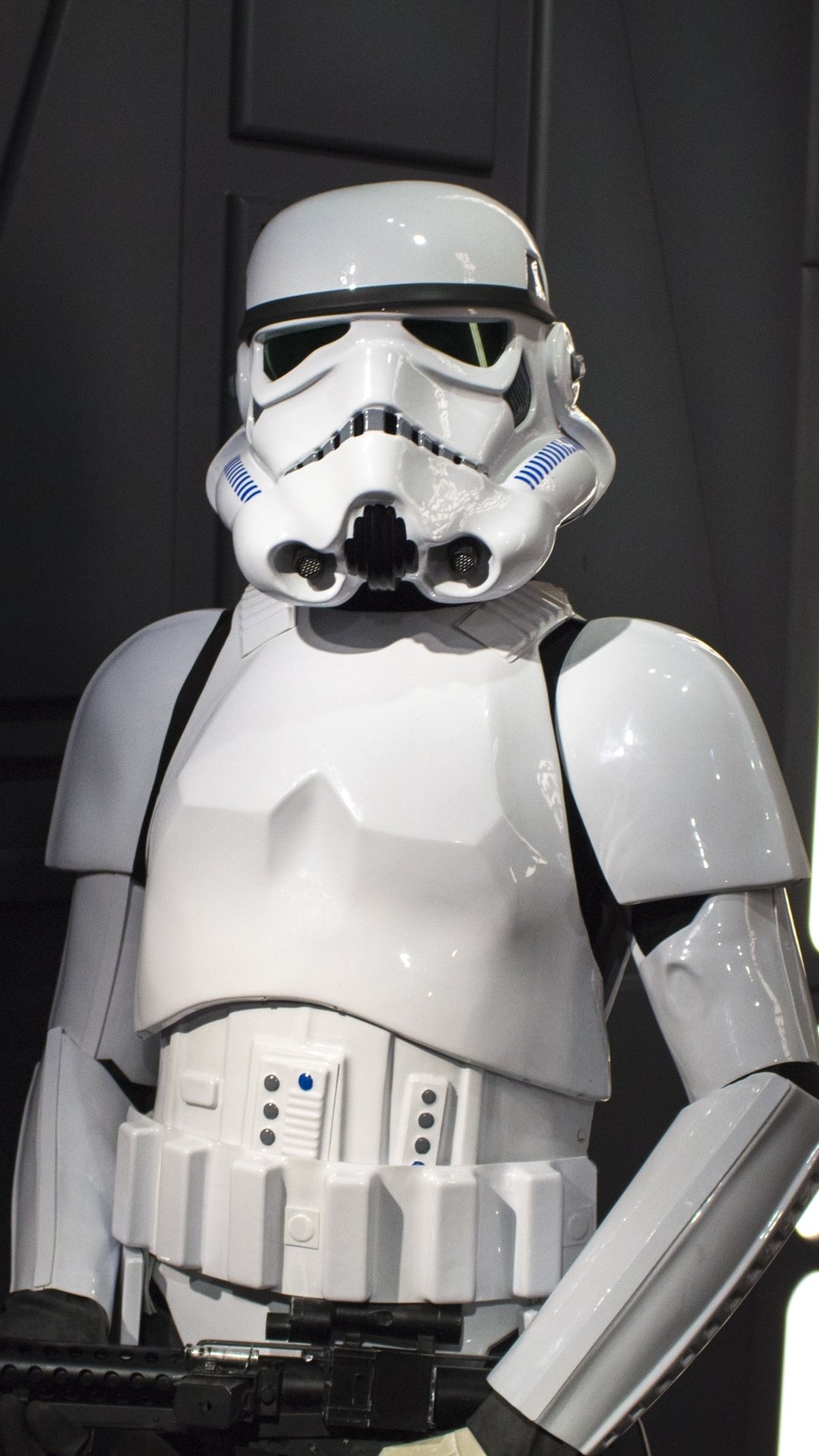 Phone wallpaper of a glossy white Star Wars stormtrooper standing against a dark sci-fi backdrop.