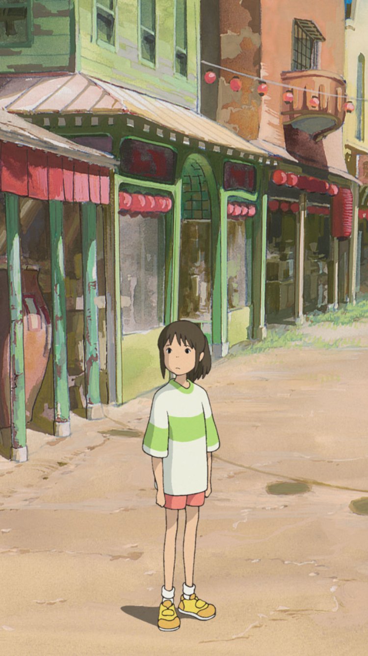 Phone wallpaper: Chihiro from Spirited Away stands alone on a sunlit, pastel street lined with old bathhouse shops.