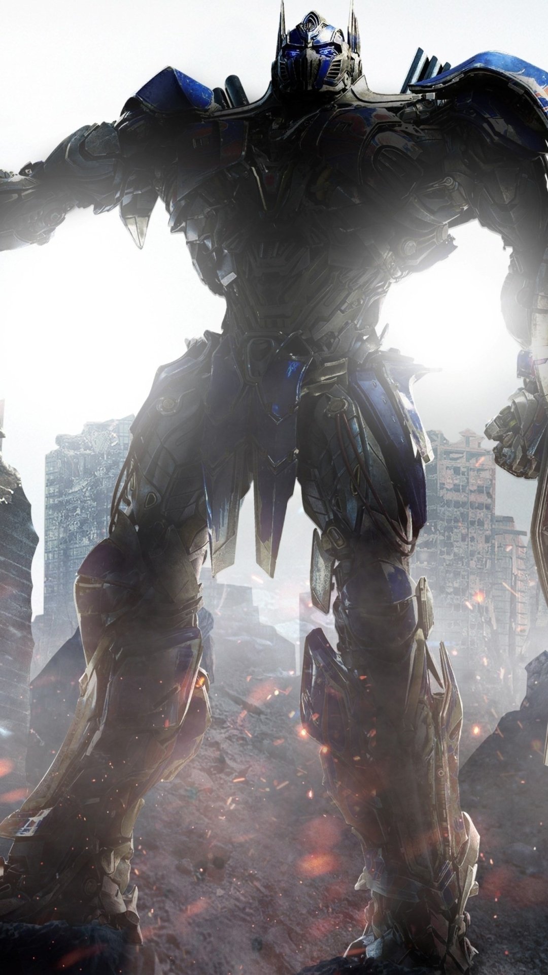 Phone wallpaper of Optimus Prime from Transformers: The Last Knight, standing tall with sword and shield amid smoky city ruins, backlit and imposing.