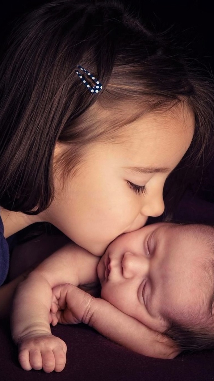 Little Girl Kissing Her Baby Brother