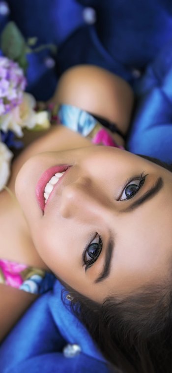  Smiling girl holding flowers by Sakrapee Nopparat