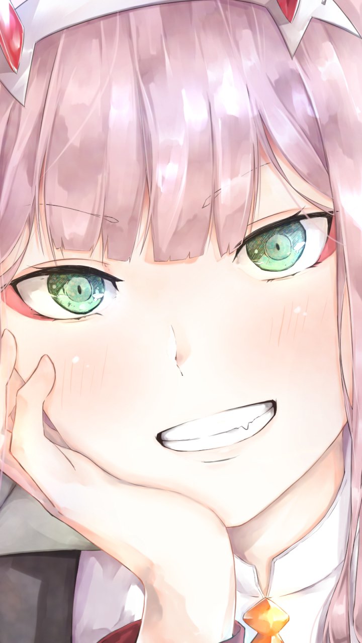 Close-up anime phone wallpaper of Zero Two from Darling in the FranXX, featuring her signature pink hair, green eyes, and playful smile, designed for iPhone and Android screens.
