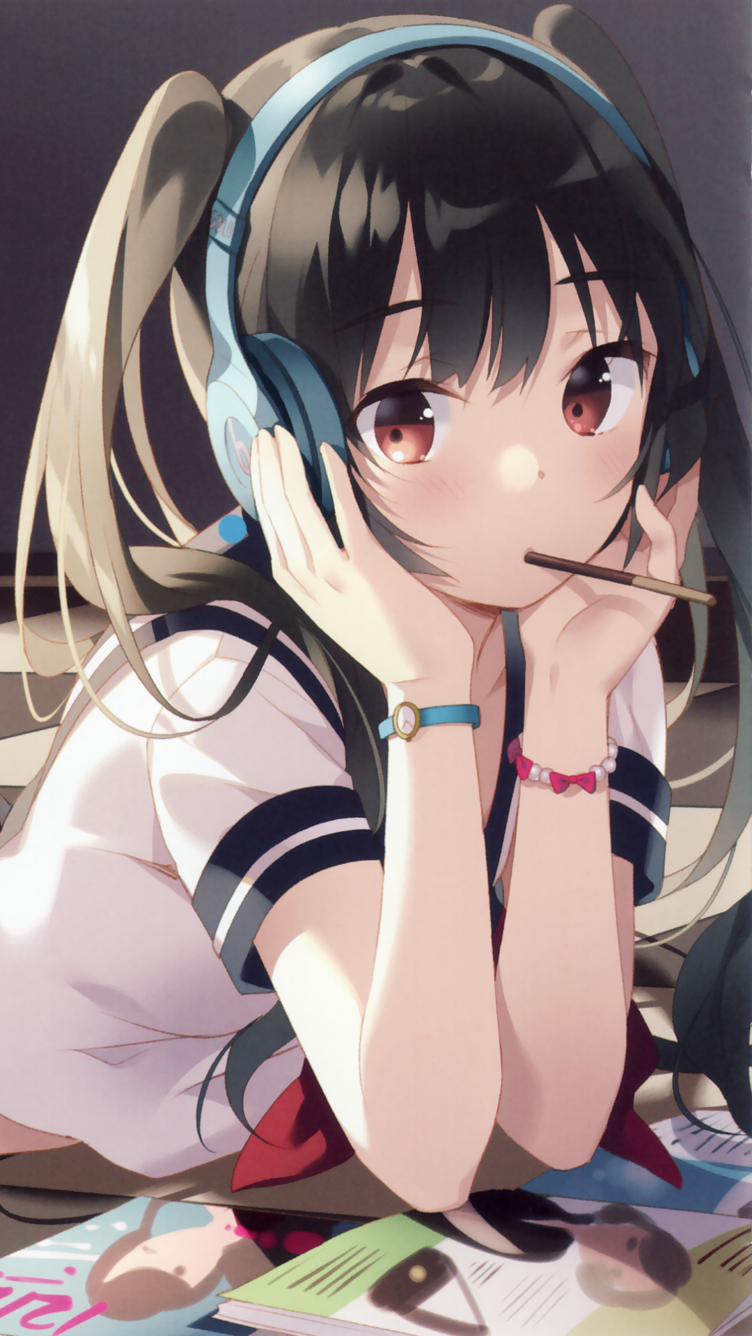 Phone wallpaper of an anime girl with black twintails and brown eyes, blushing while wearing headphones, leaning over a book and holding a snack stick.