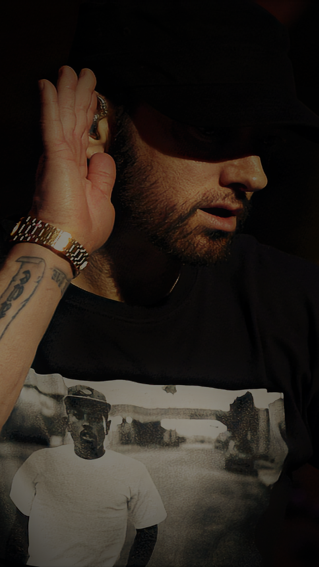 Phone wallpaper featuring a close-up of Eminem in shadow with his hand to his ear, blending music and urban style, compatible with iPhones and Android devices.