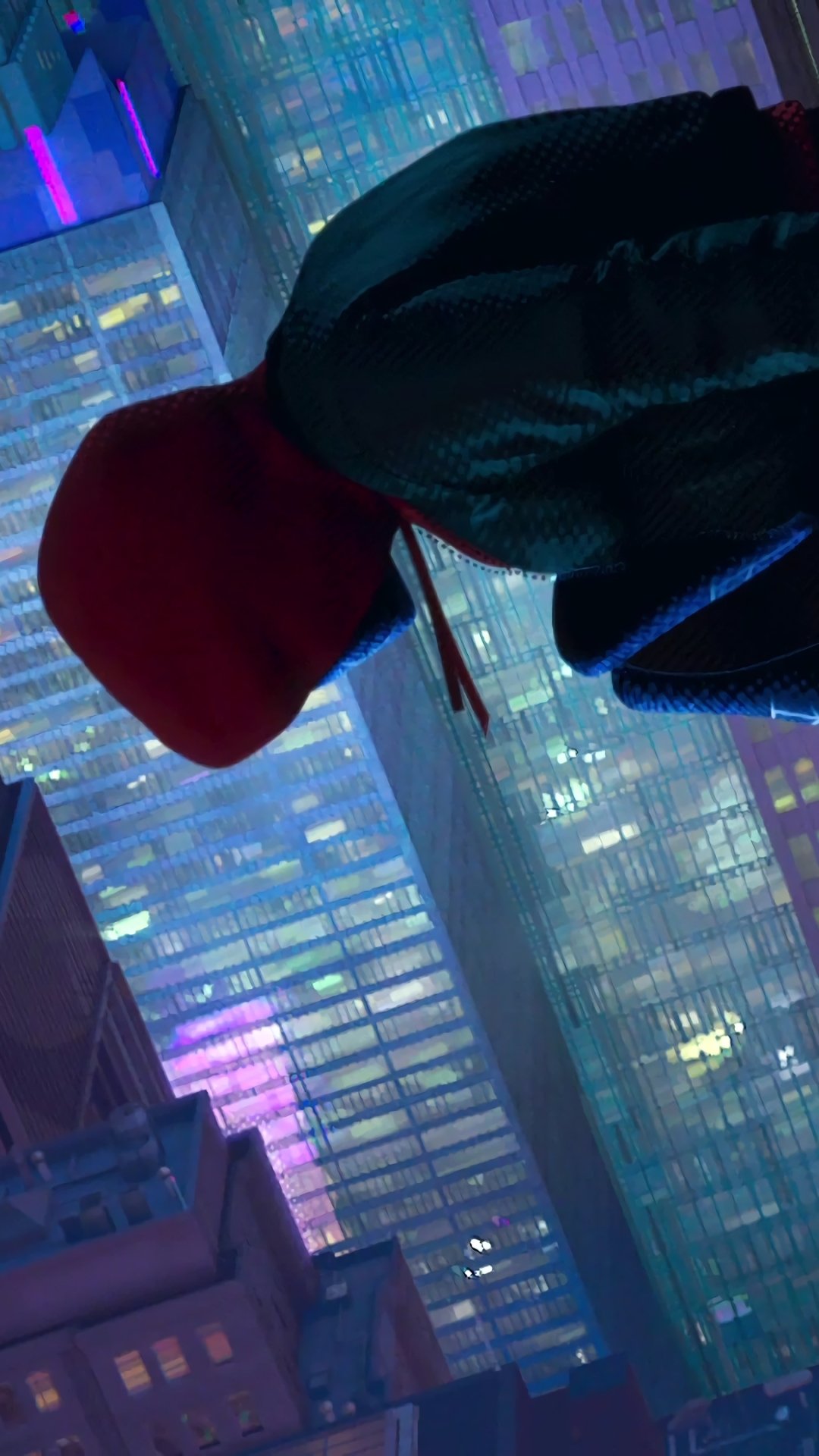 Phone wallpaper of Miles Morales in a red hood and mask against neon-lit skyscrapers — Spider-Man: Into the Spider-Verse.
