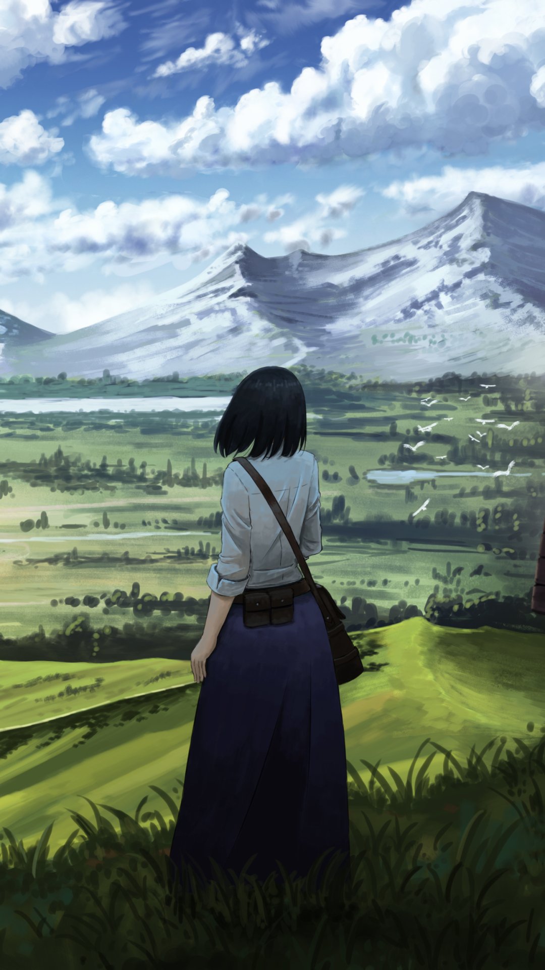 Anime original phone wallpaper: short black-haired figure with a bag stands on a grassy hill overlooking a valley of fields and snowy mountains under a cloud-filled sky.