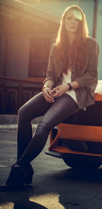orange car jeans jacket car vehicle Ford Mustang redhead long hair woman Girls & Cars Phone Wallpaper