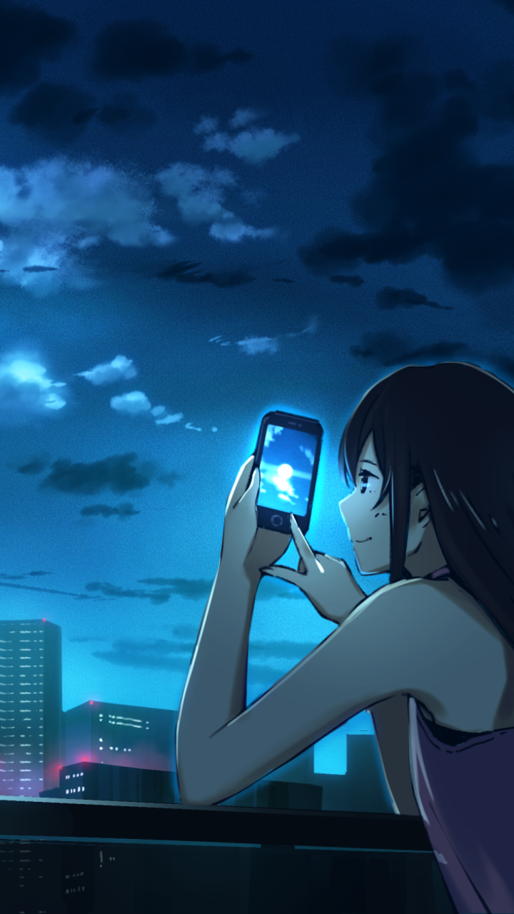 Phone wallpaper, anime original: long black-haired girl on a rooftop under a moonlit sky, holding a smartphone that reflects the moon, city lights glowing below.