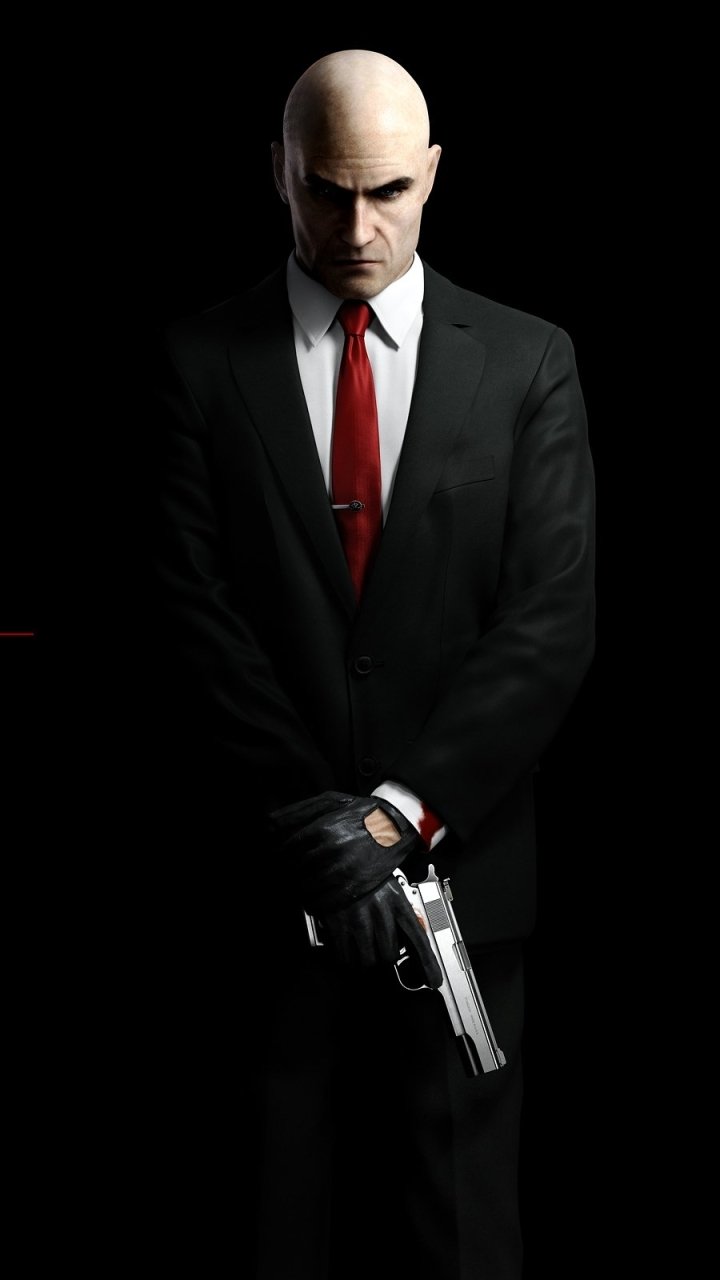 Phone wallpaper of Agent 47 from Hitman: Absolution, featuring a black background and the character in a black suit with a red tie, holding a silver handgun.