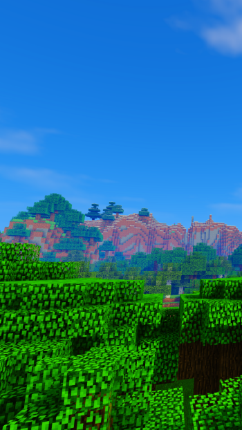 Phone wallpaper from the video game Minecraft: blocky green forest in the foreground, mesas and spruce hills beyond, under a bright blue sky with scattered clouds.