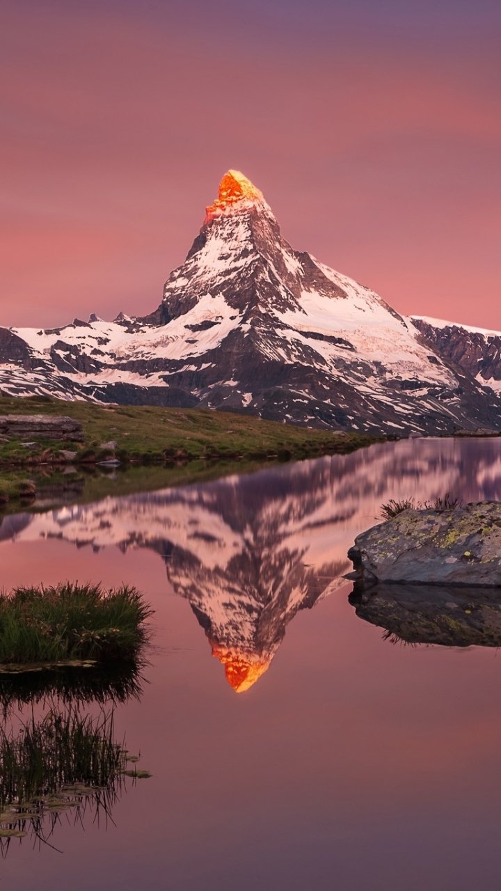 A striking phone wallpaper showcasing the Matterhorn mountain peak at sunset, reflected in a serene lake, capturing natural beauty for both iPhone and Android screens.