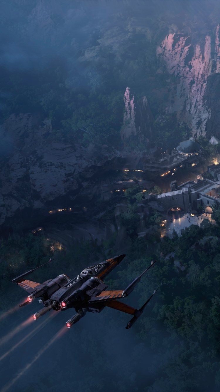 Phone wallpaper showing a Star Wars X‑Wing flying low over a misty mountain town at dusk, engines glowing — moody sci‑fi scene.