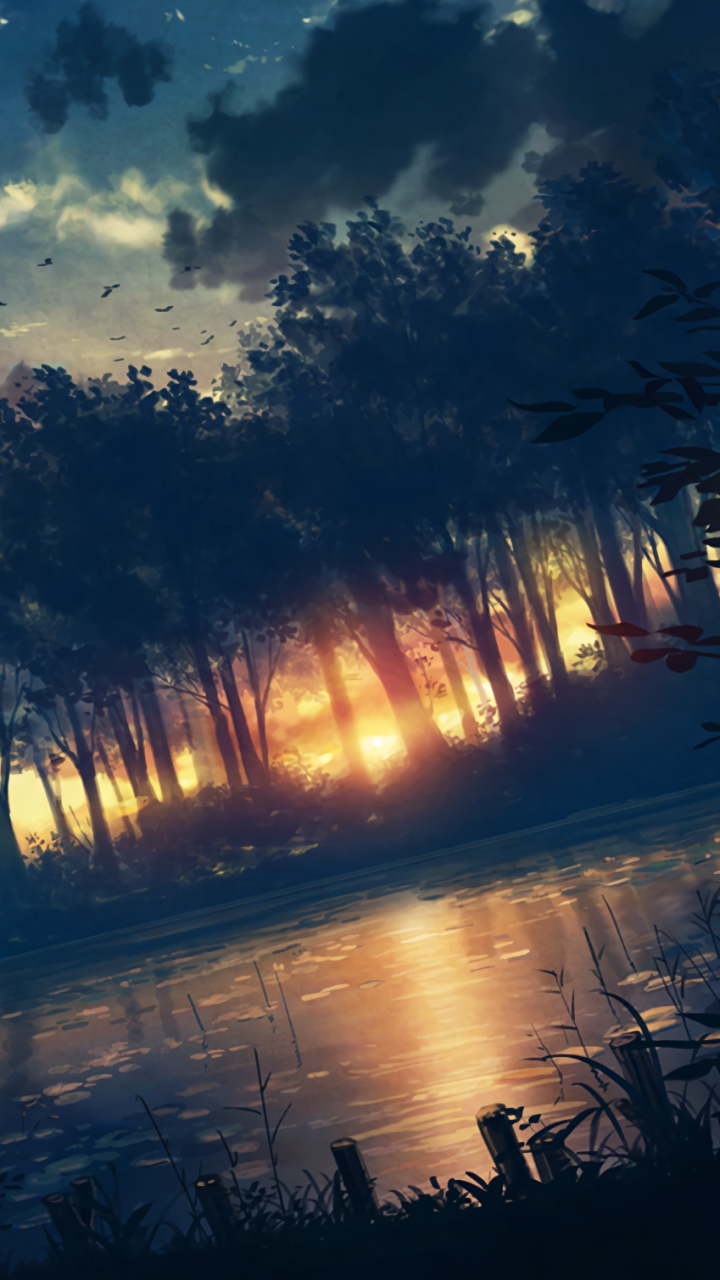 Vertical anime phone wallpaper: warm anime-sunset light through a dense forest, trees reflected on a calm pond, silhouetted birds drifting above — serene anime forest scene.