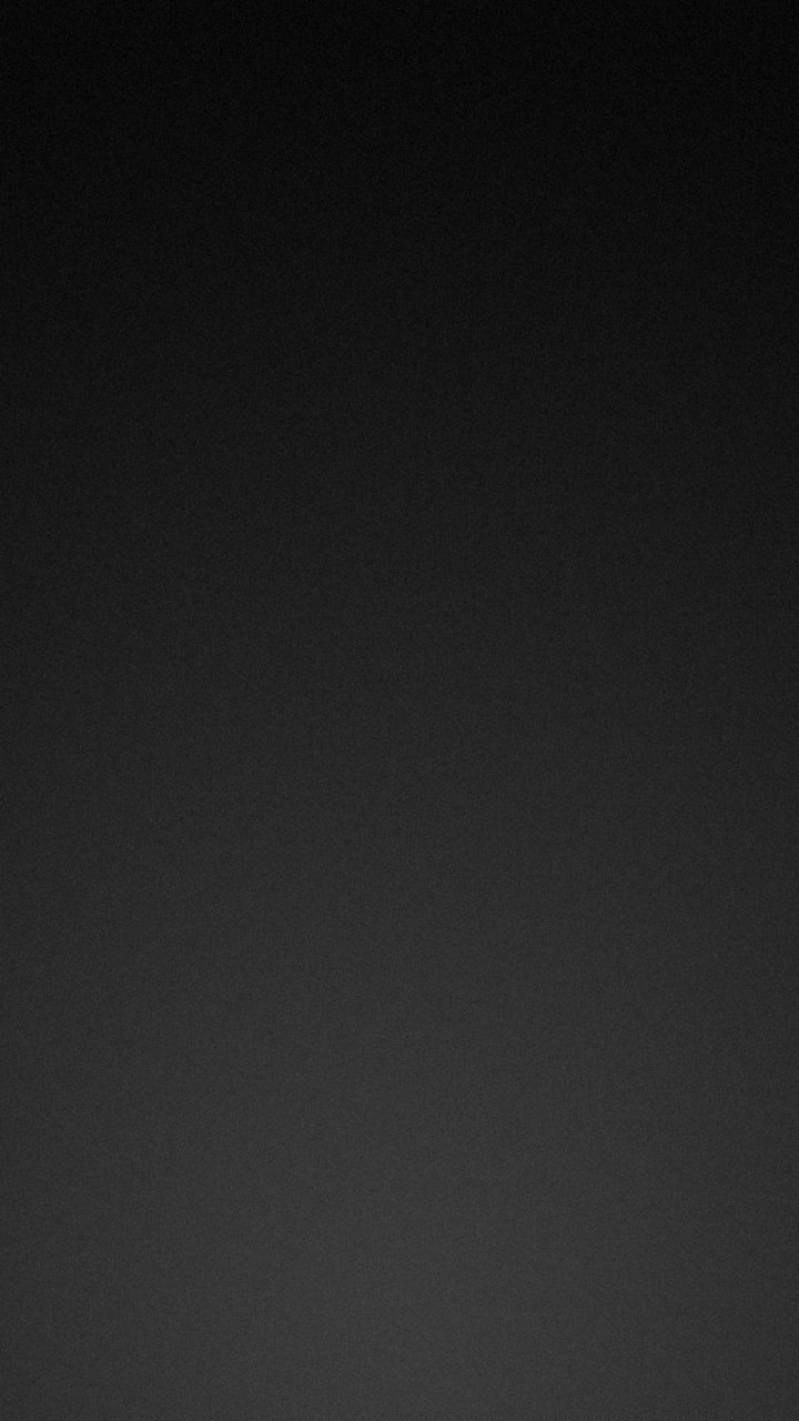 Abstract black phone wallpaper with a subtle vertical dark gradient and fine grain texture, minimalist abstract mobile background.
