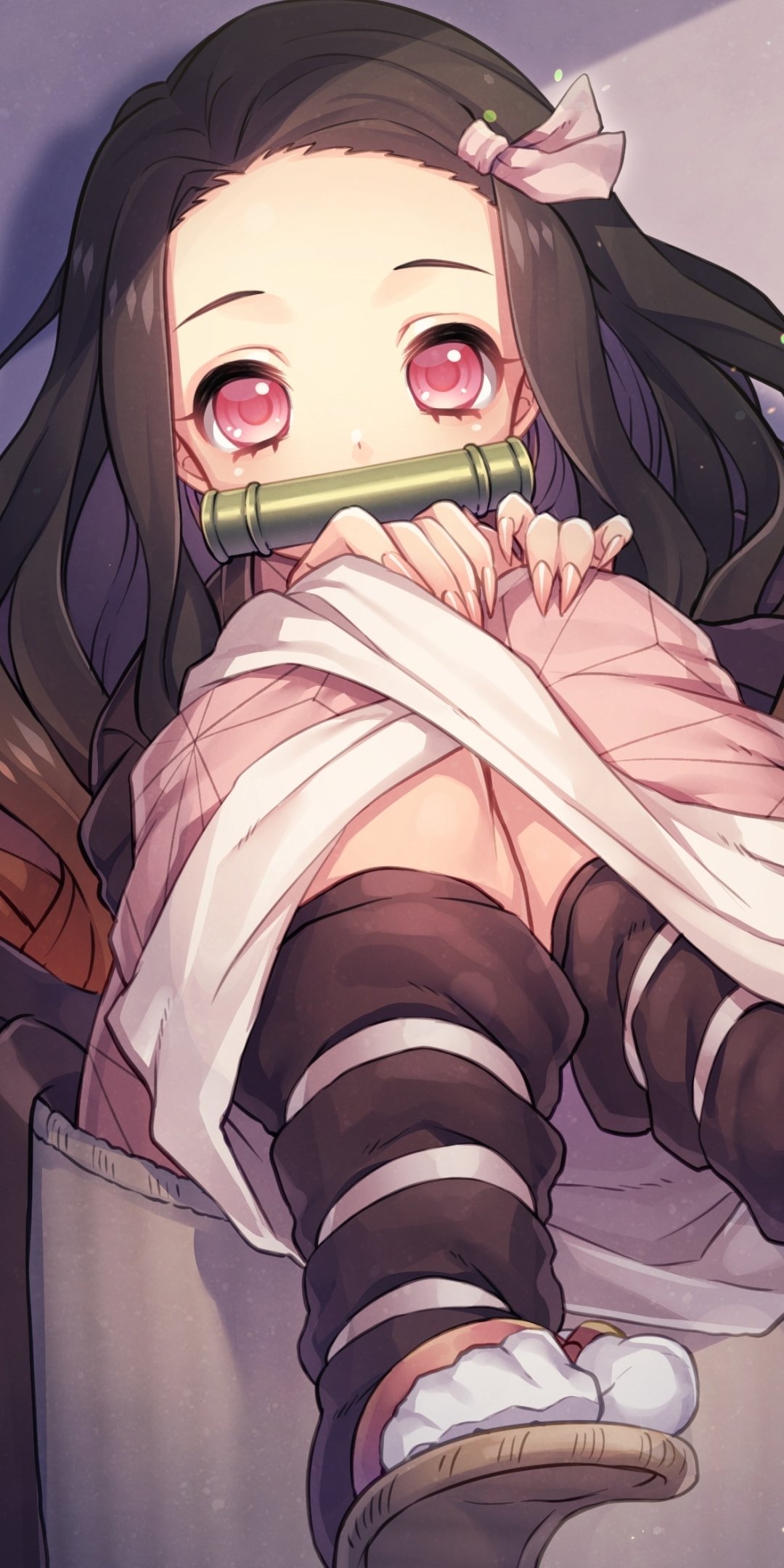 Anime phone wallpaper of Nezuko Kamado from Demon Slayer: Kimetsu no Yaiba — seated with bamboo muzzle, pink eyes, long dark hair and a ribbon.