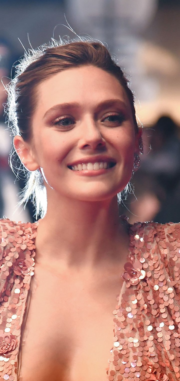 Phone wallpaper: close-up portrait of a smiling woman in a sequined gown at an event; tagged celebrity, Elizabeth Olsen — identity cannot be confirmed.
