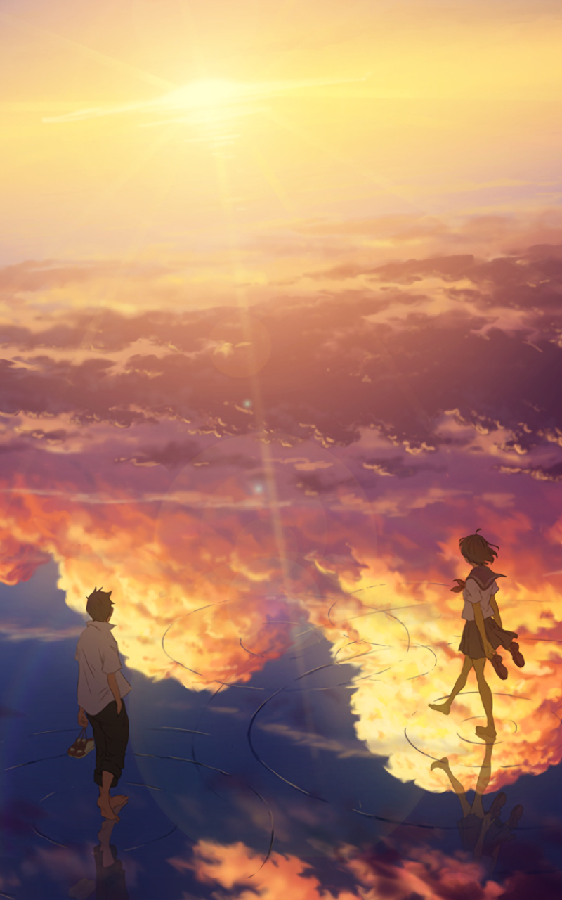 Anime phone wallpaper: two figures on a mirror-like surface beneath a golden sunset sky, glowing clouds and sunbeams reflected around them.