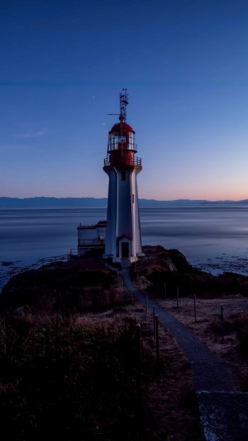 horizon ocean man made lighthouse Phone Wallpaper