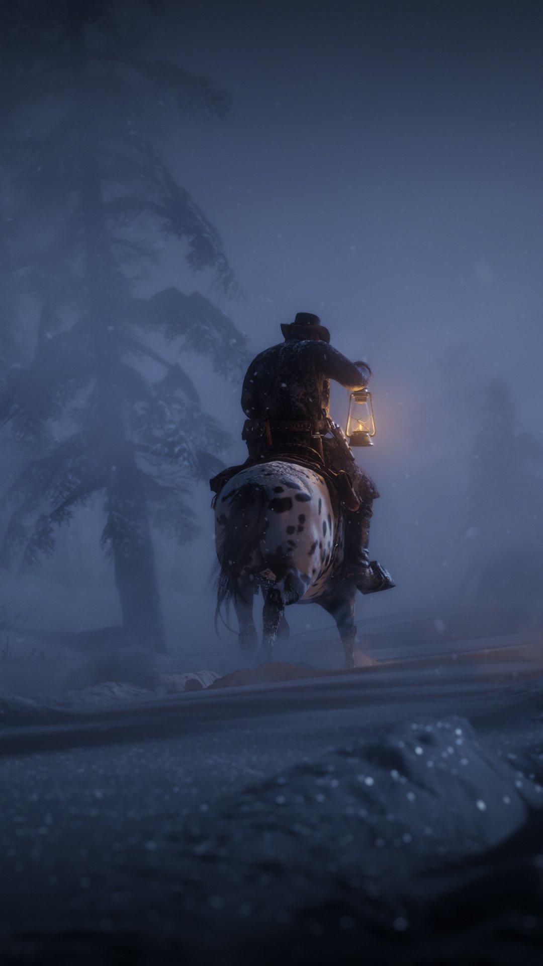 Phone wallpaper featuring a foggy night scene from Red Dead Redemption 2, showing a rider on horseback holding a lantern on a snowy path, compatible with iPhones and Android phones.