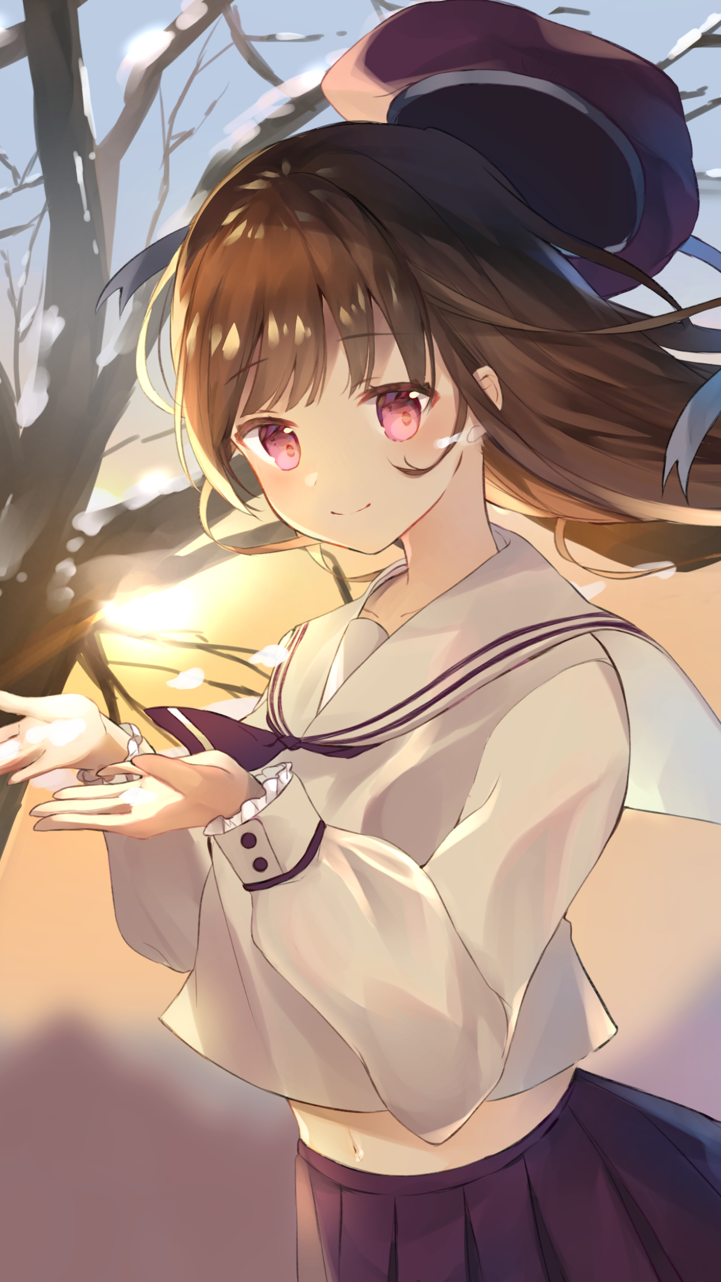 Phone wallpaper of an anime girl with brown hair and pink eyes in a sailor school uniform, holding a glowing light against a warm sunset and snowy branches backdrop.