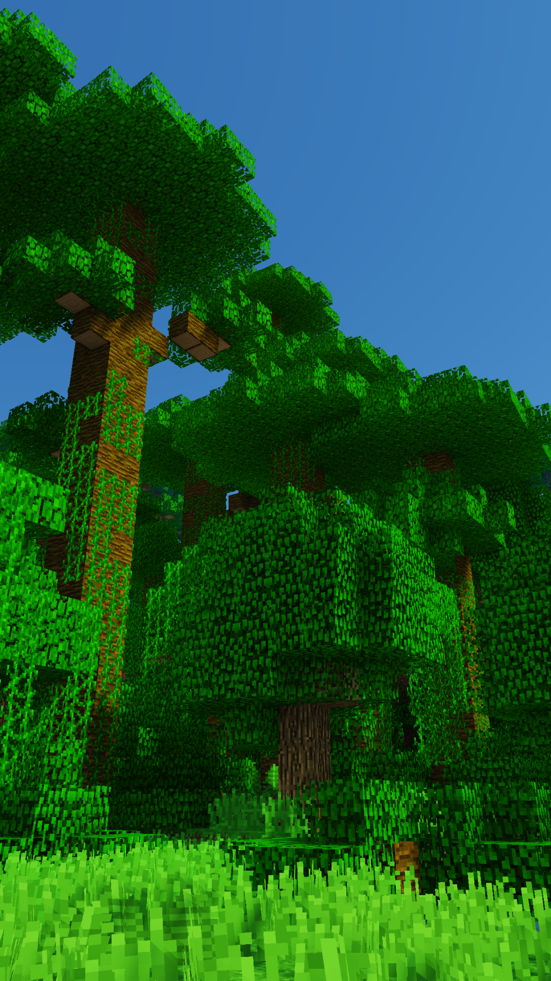 Minecraft jungle scene with lush green trees and clear blue sky, designed as a vibrant phone wallpaper for iPhones and Android devices.
