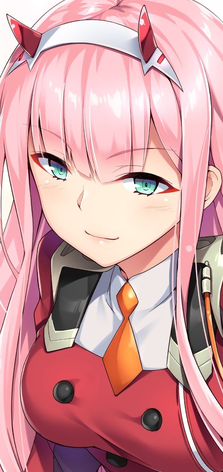 Phone wallpaper close-up of Zero Two from Darling in the FranXX, anime portrait with pink hair, horn headband, teal eyes, red pilot suit and a playful smirk.