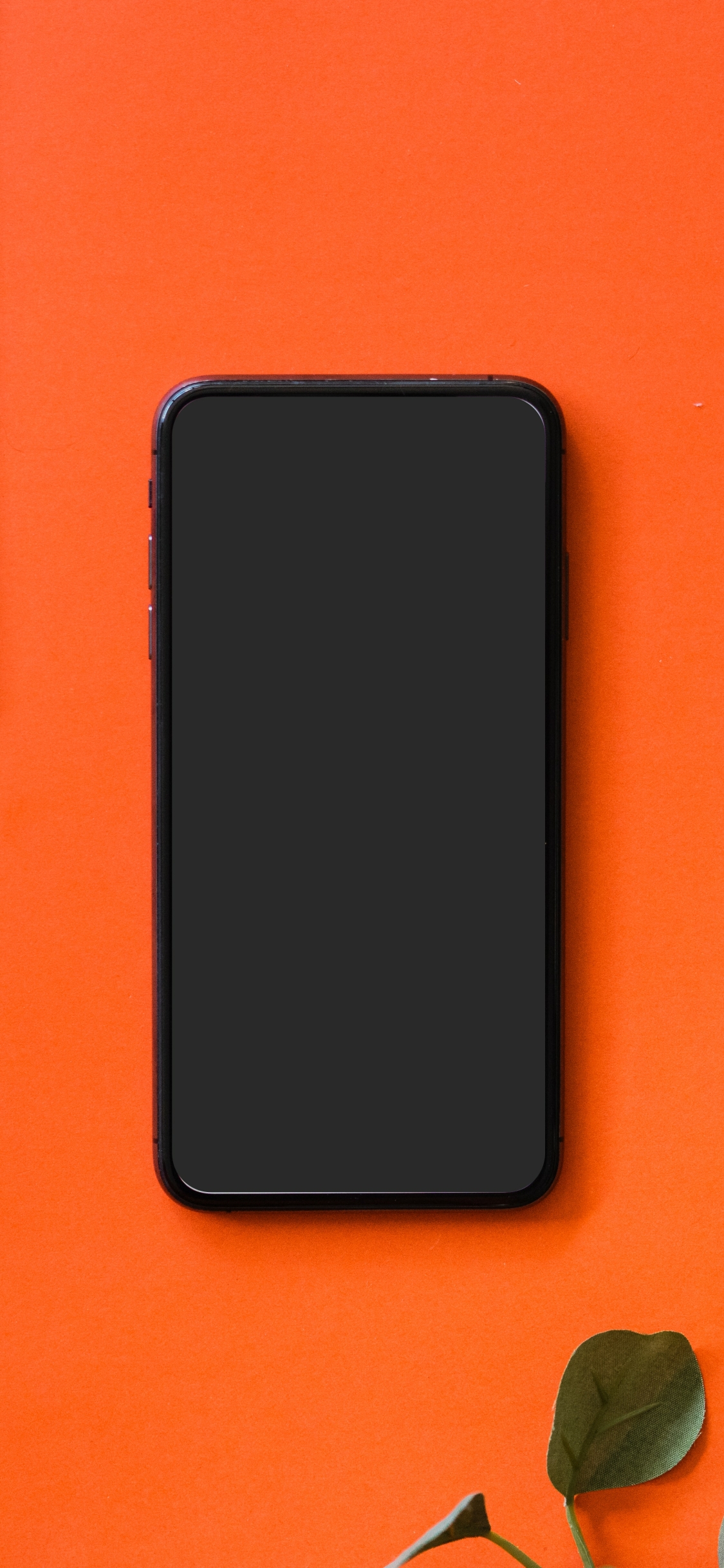Black iPhone 5 on orange surface