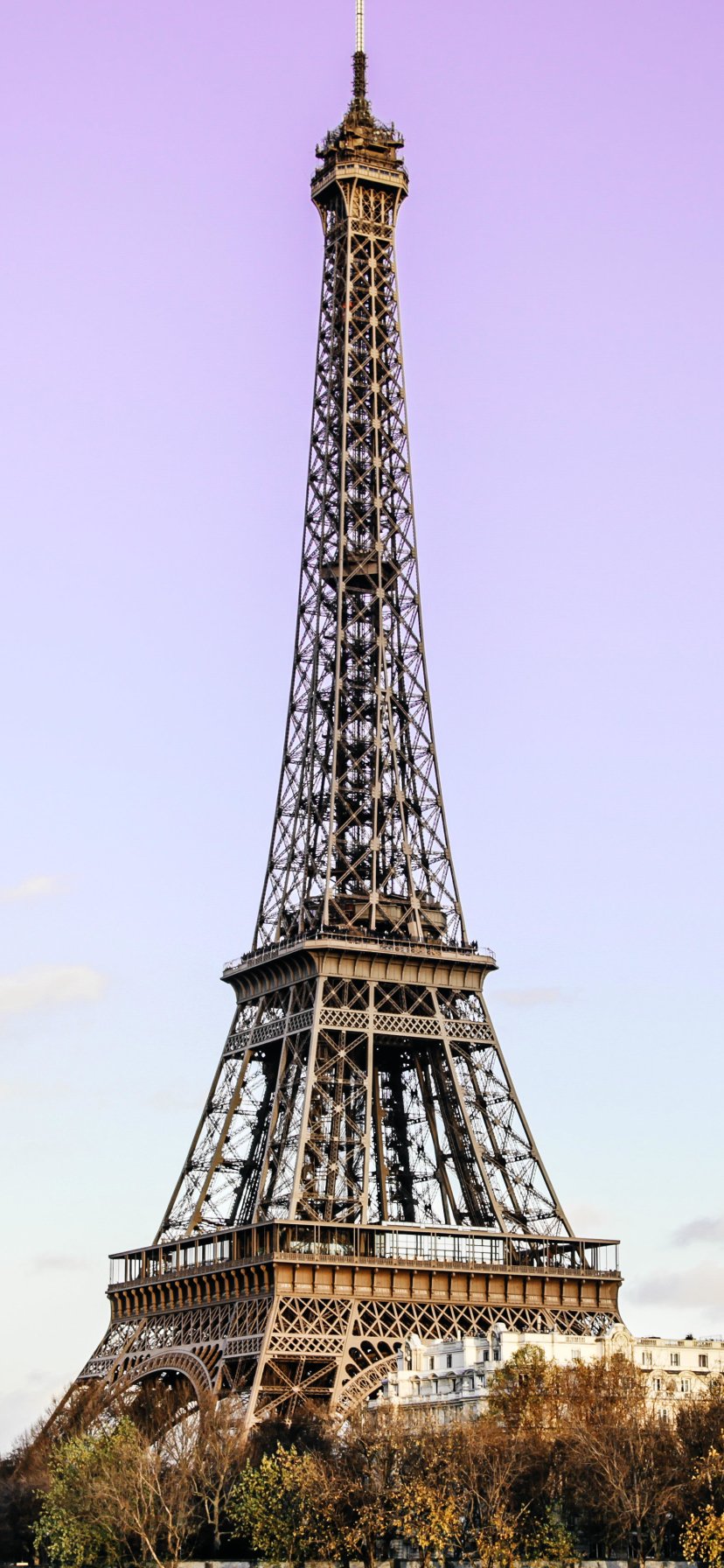 Eiffel Tower in Paris, France rising against a lavender sky — a tall man-made monument framed vertically as a phone wallpaper.
