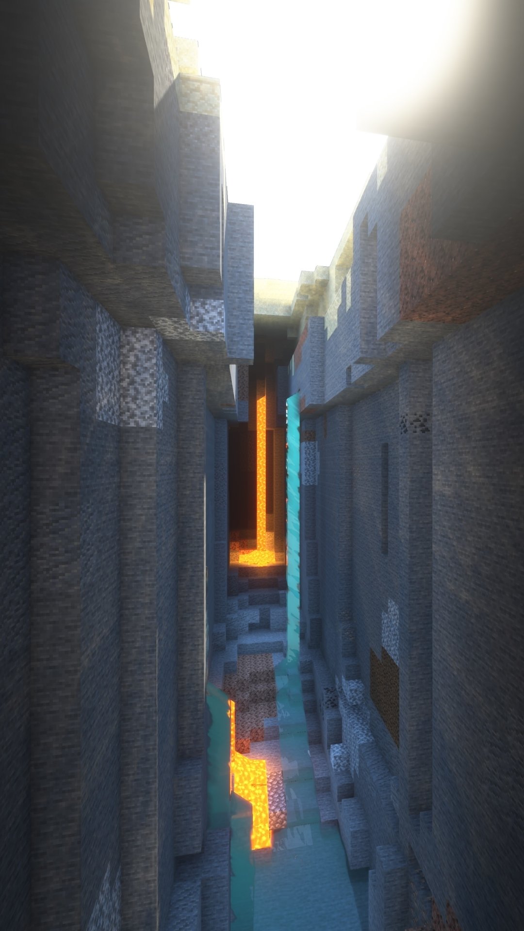Phone wallpaper featuring a vertical Minecraft scene of a deep ravine with lava flow between towering stone cliffs, designed for both iPhone and Android screens.