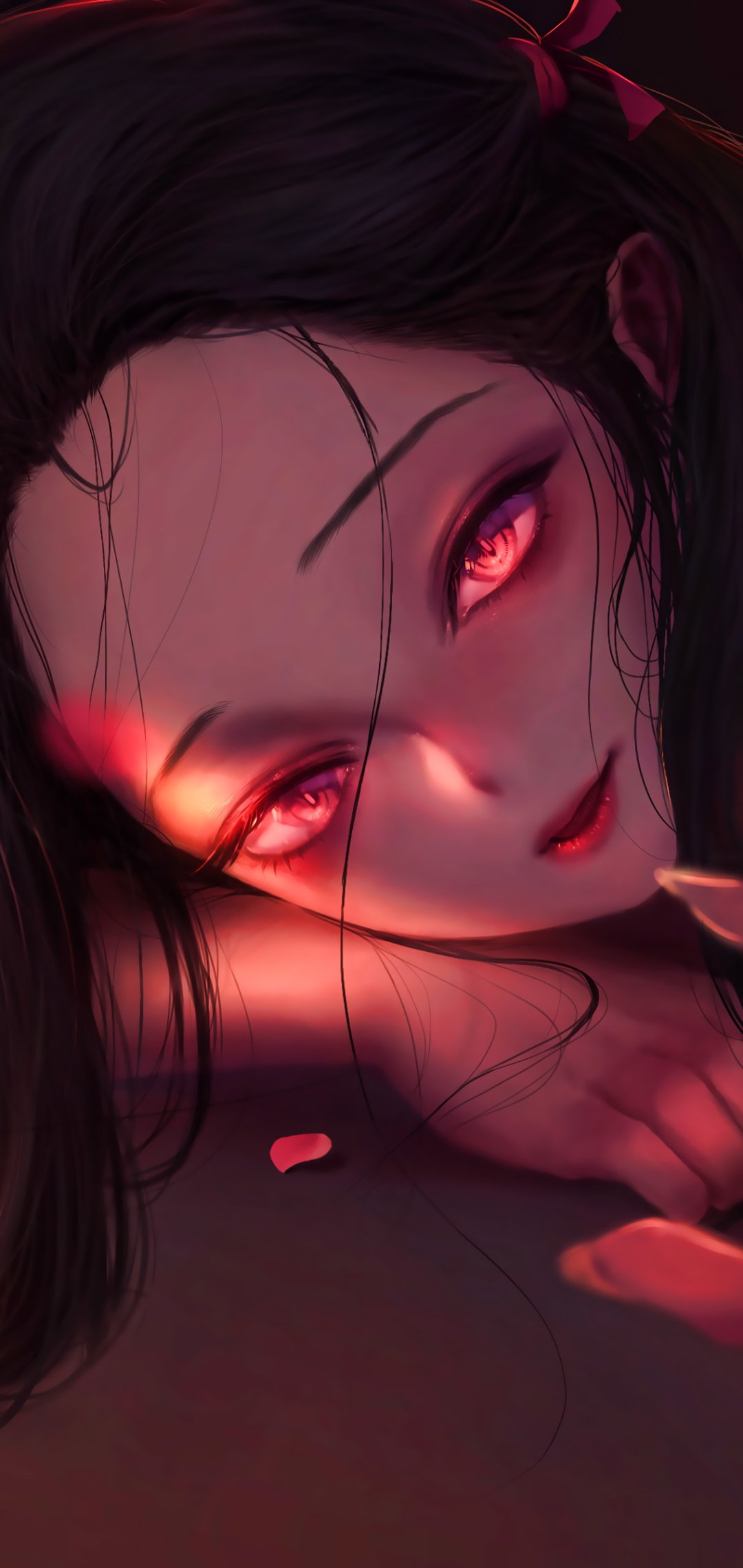 Phone wallpaper of Nezuko Kamado (Demon Slayer: Kimetsu no Yaiba): close-up, reclining face with glowing pink-red eyes, loose dark hair, scattered petals and warm moody lighting.