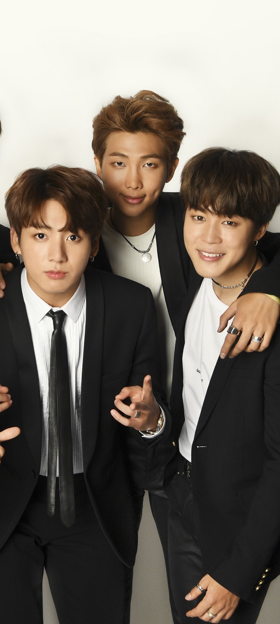 Phone wallpaper featuring BTS members Jungkook, RM, and Jimin dressed in black suits, styled for a music-themed background compatible with iPhones and Android devices.