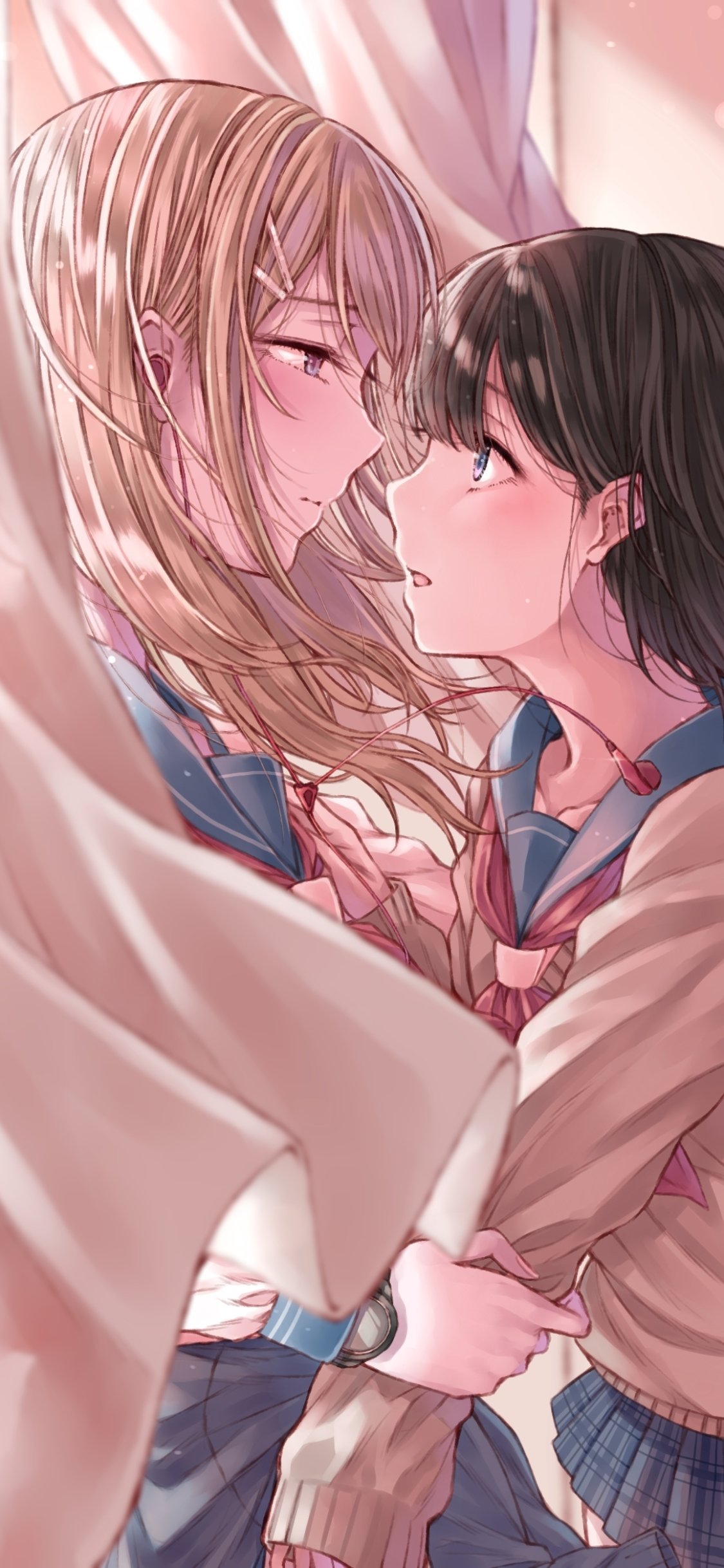 Phone wallpaper of two anime girls in school uniforms—a blonde and a dark-haired girl—sharing a tender, close gaze in soft pink light framed by flowing curtains.