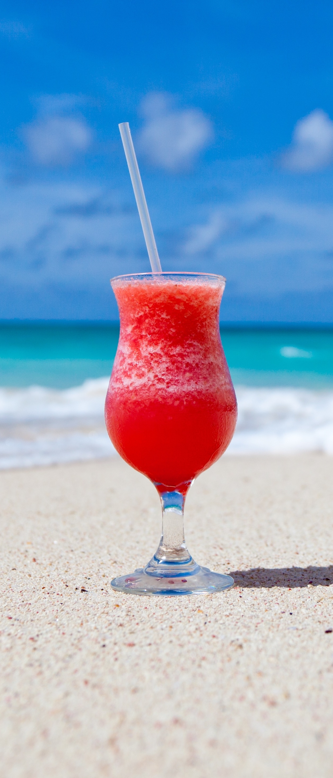Ice cold red beverage on a caribbean beach by PublicDomainPictures