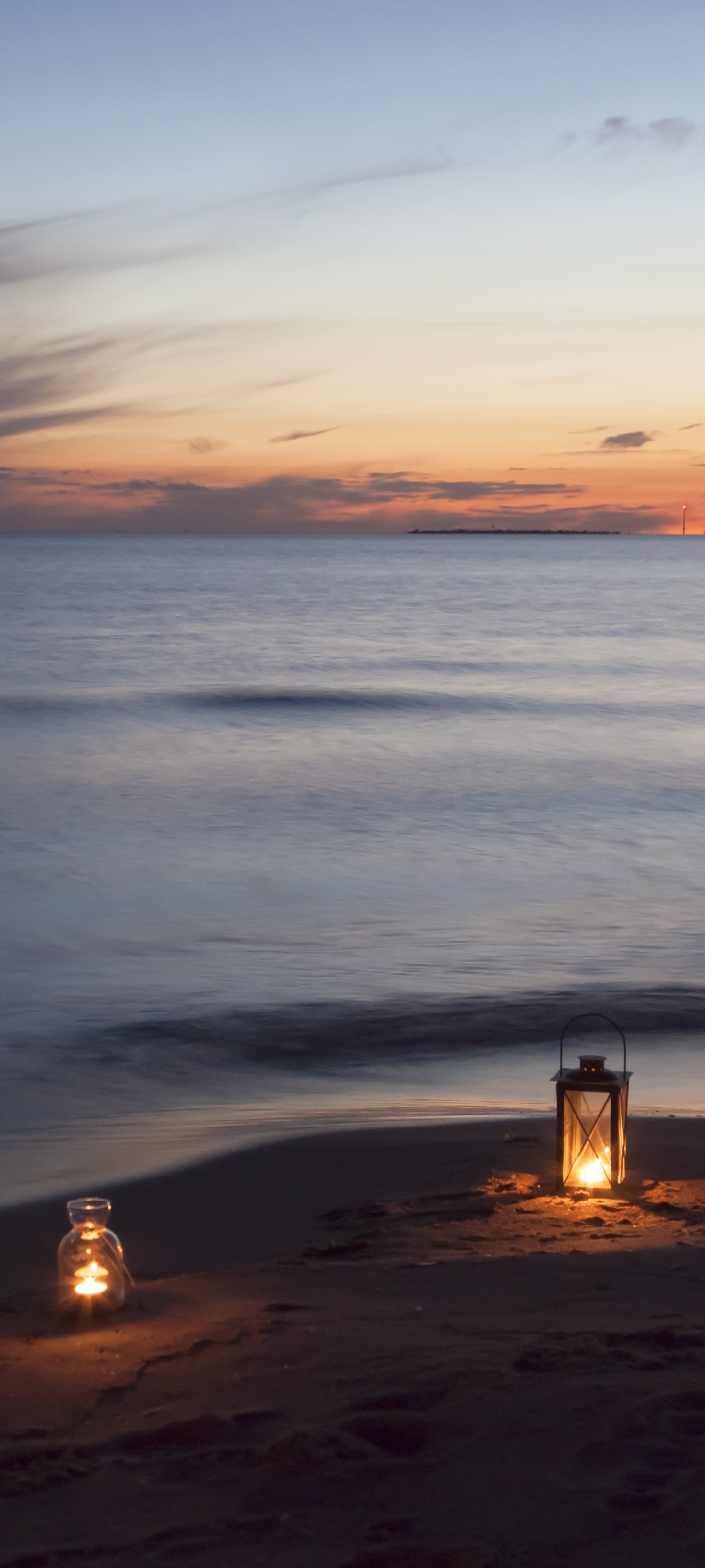 Lanterns on a deserted beach at sunset by LTapsaH