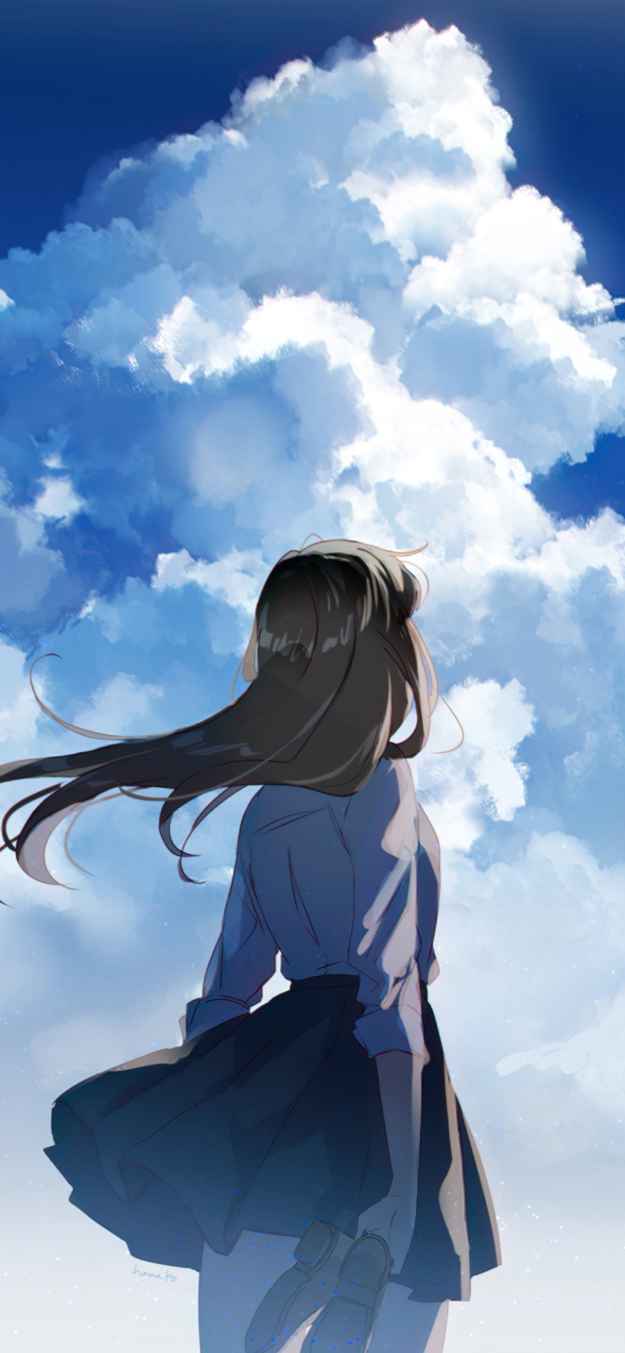 Phone wallpaper showing an anime girl in a school uniform standing with hair blown by wind, gazing up at towering sunlit clouds against a deep blue sky.