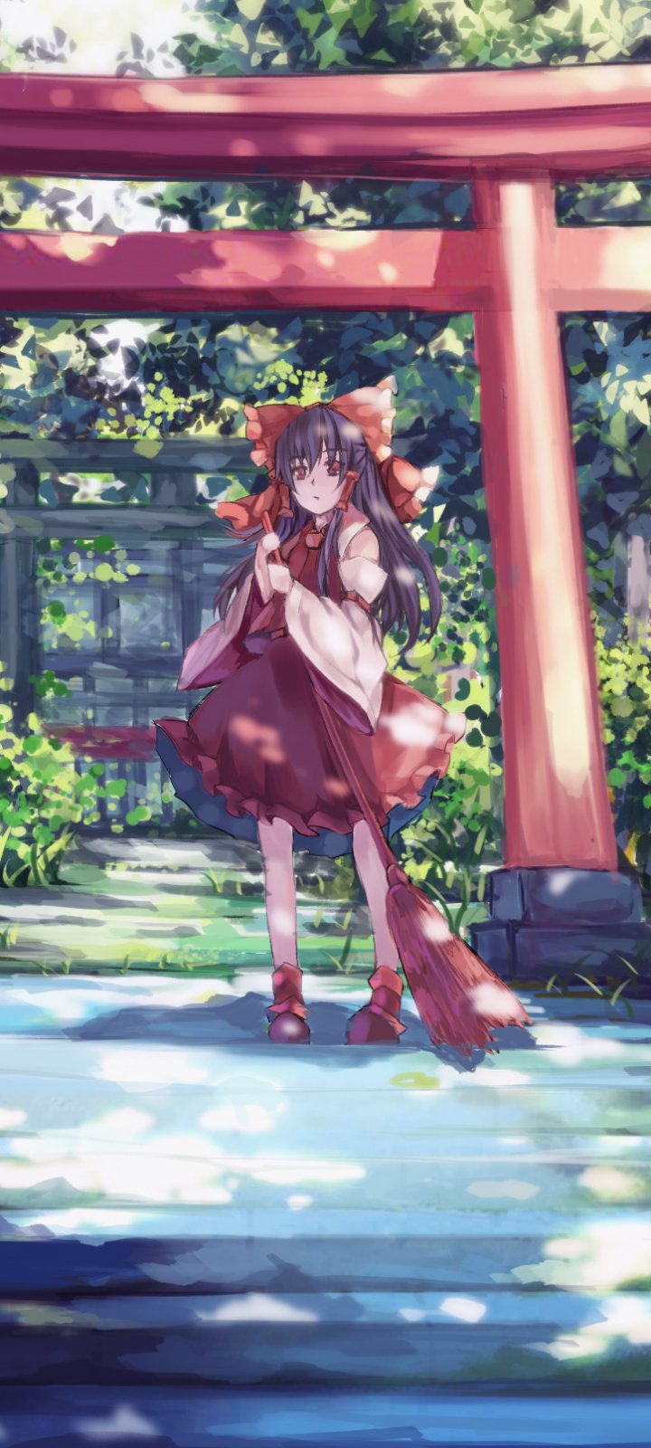 Phone wallpaper of Reimu Hakurei (Touhou) — anime-style scene of her standing beneath red torii gates in sun-dappled shrine grounds, wearing her signature shrine maiden outfit.