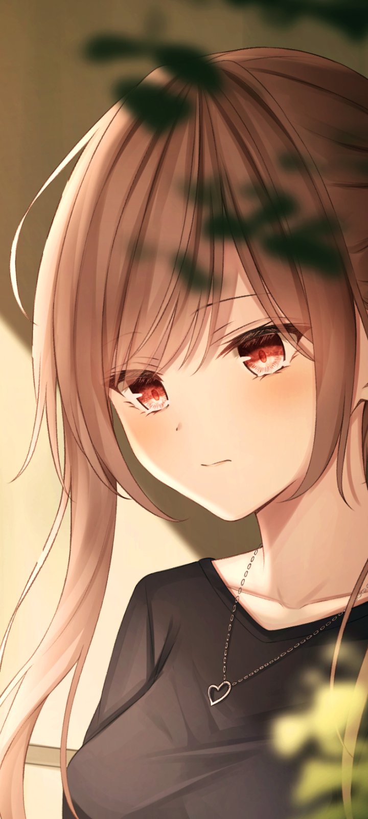 Phone wallpaper of an anime girl with long light-brown hair and soft red eyes, wearing a black top and heart necklace, gentle expression framed by blurred foliage.