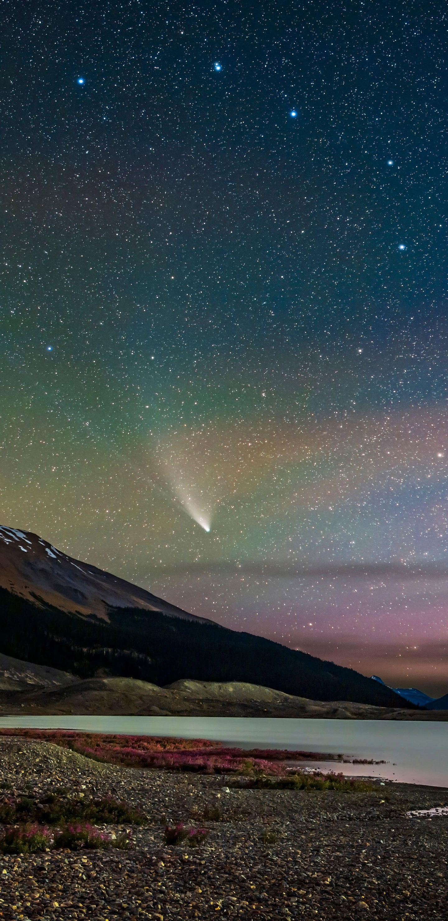 Comet NEOWISE streaks across the sky over Sunwapta Lake in Jasper National Park, Alberta, Canada