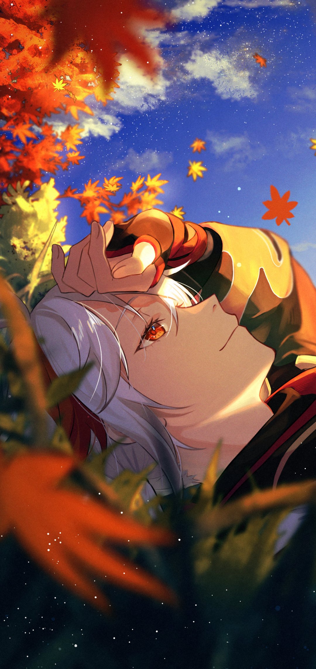 Phone wallpaper of Kaedehara Kazuha (Genshin Impact) reclining in grass beneath a blue sky, hand shading his eyes as amber maple leaves drift around him.